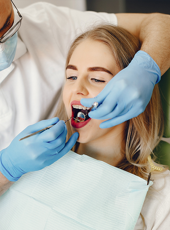 Dentist performing a gentle dental checkup on an adult patient at Dentique clinic in central Dublin near Merrion Square Park