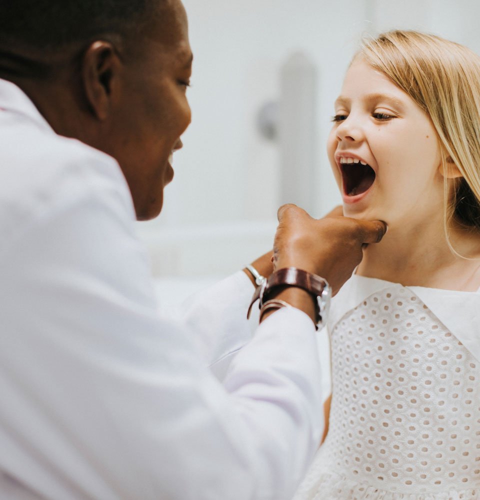 Smiling child receiving an oral examination at Dentique dental clinic in Dublin